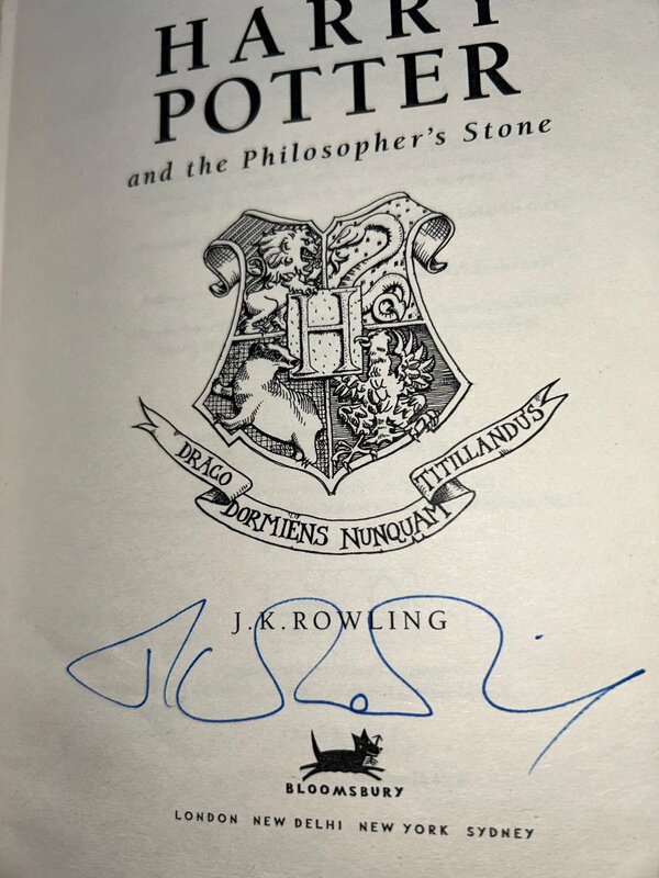 Title page: Hogwarts crest and J.K. Rowling's signature